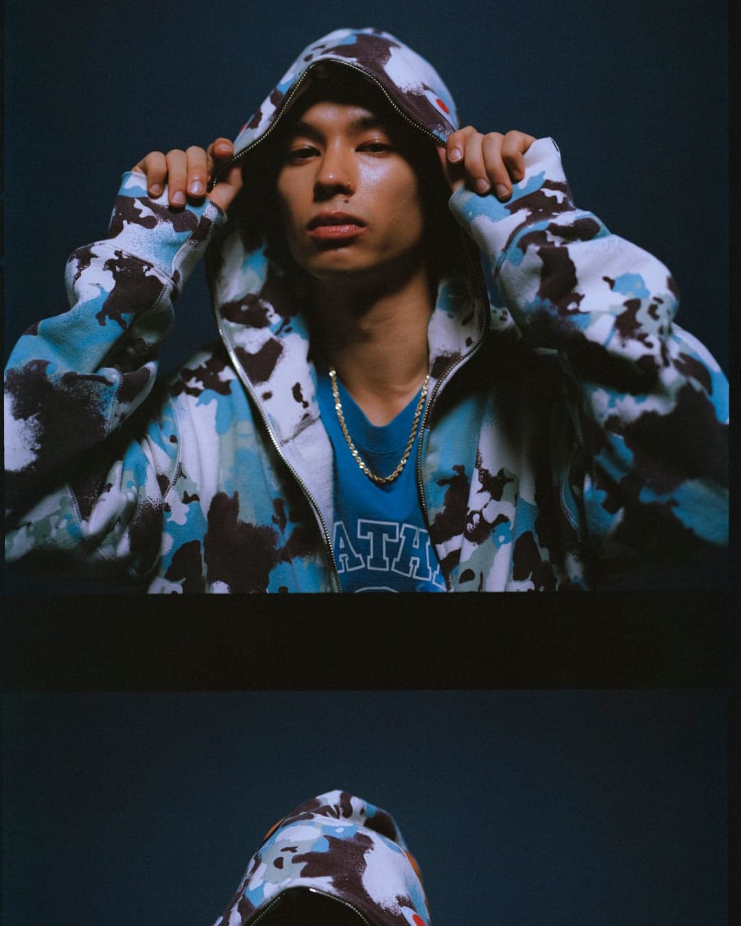 Model wearing a blue and black camouflage zip hoodie
